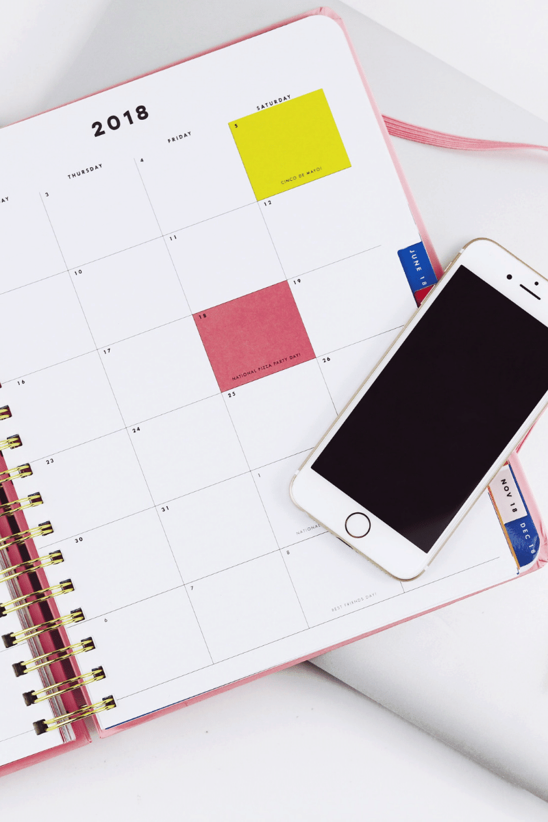 Monthly planner page with cell phone on top