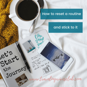 Journal with phone laying across white ceramic coffee cup to side