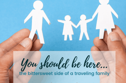 Two hands holding a paper cut-out family with father separated